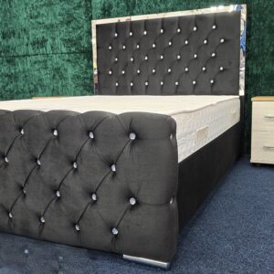 Bedroom setup featuring black velvet bed with chrome accents by ZAK Furniture