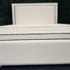 Modern white padded bed frame with chrome trim and faux leather finish by ZAK Furniture