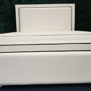 Modern white padded bed frame with chrome trim and faux leather finish by ZAK Furniture